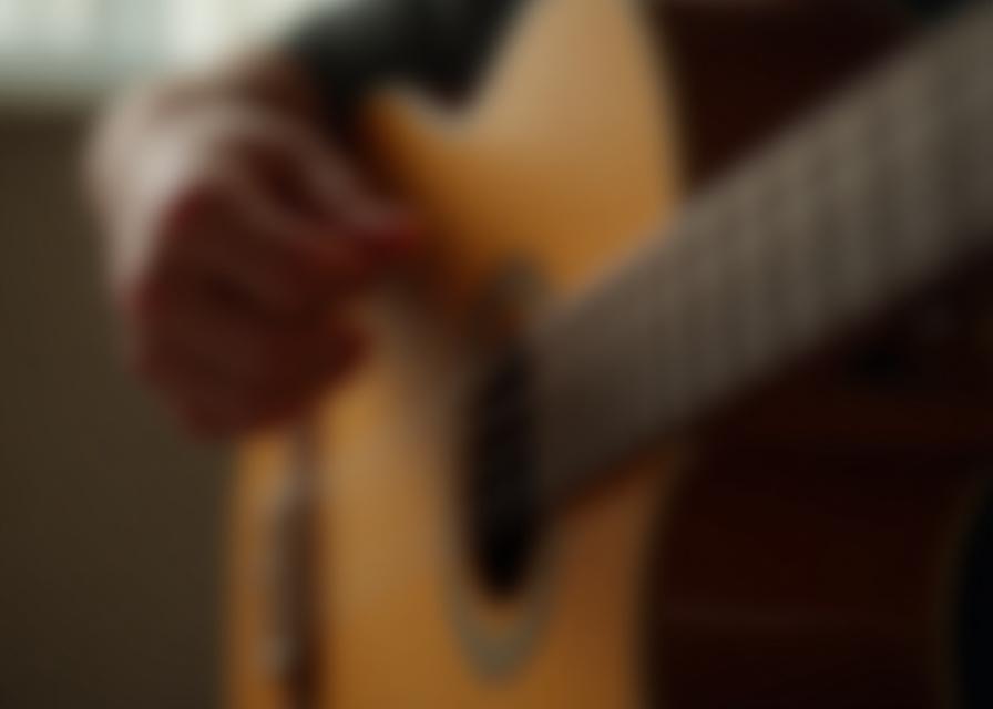 Close up of hands learning guitar chords